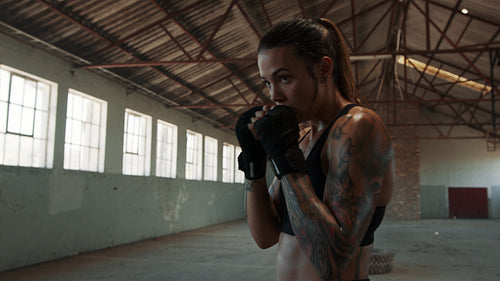 Fit young female practicing shadowboxing