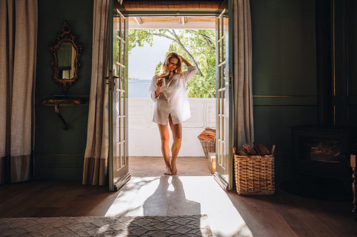 Carefree female tourist standing at a hotel entrance