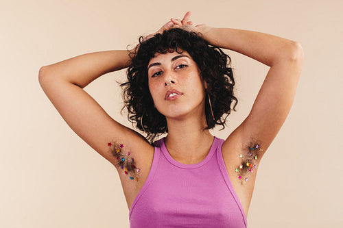Confident young woman embracing her underarm hair