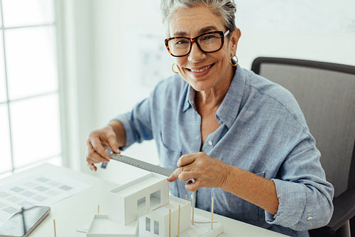 Mature business woman working in the design and planning phase of a construction project