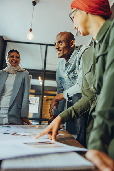 Cheerful designers working together in a creative workplace