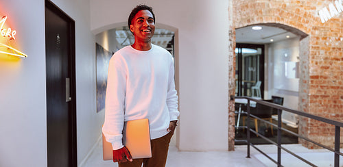 Happy businessman smiling while standing alone