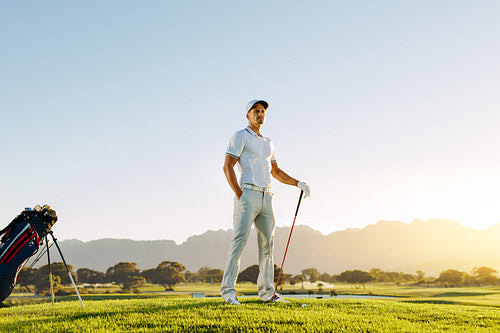 Caucasian male golfer standing on golf course