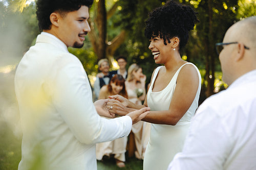 Joyful wedding ceremony in an outdoor garden setting with happy couple