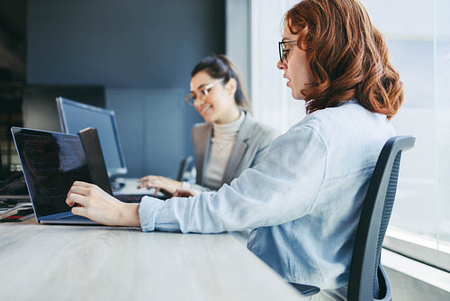 Professional business team discussing software development in a modern office