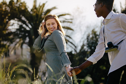 Interracial couple walking hand in hand