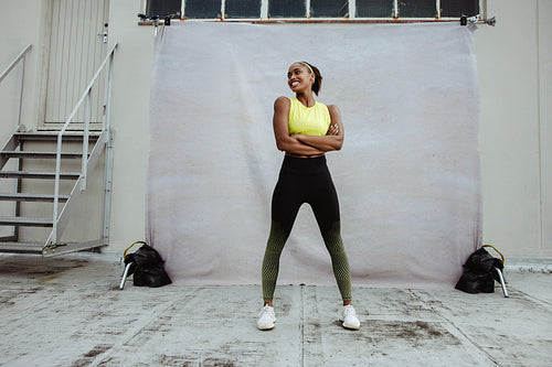 African woman relaxing after workout session on rooftop