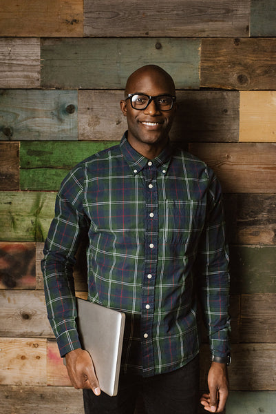 Young student with laptop smiling