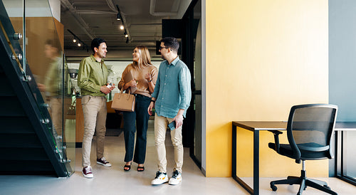 Young professionals walking and conversing in a modern creative office environment