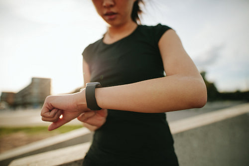 Fitness woman checking her performance on smartwatch