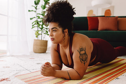 Beautiful fitness woman doing plank workout at home