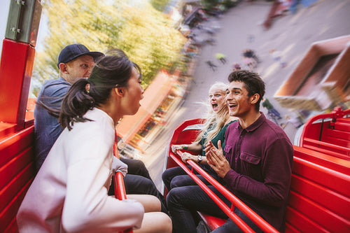 Happy young friends having fun on amusement park ride