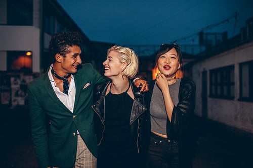 Friends walking on the street at night