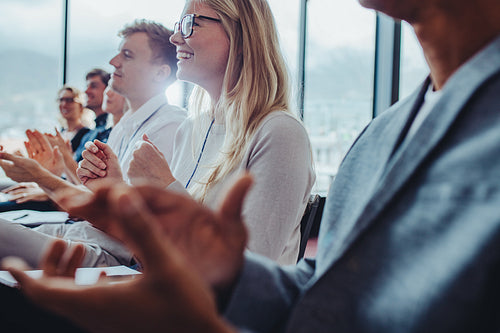 Businesspeople clapping hands after successful conference