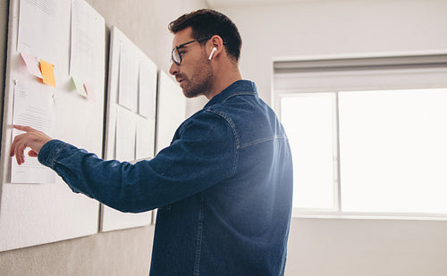 Businessman reading a report during a virtual meeting