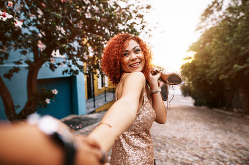 Happy young woman having fun walking on street.
