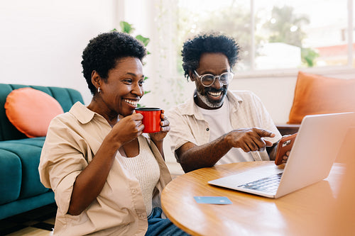 Couple watching a funny video together on a laptop