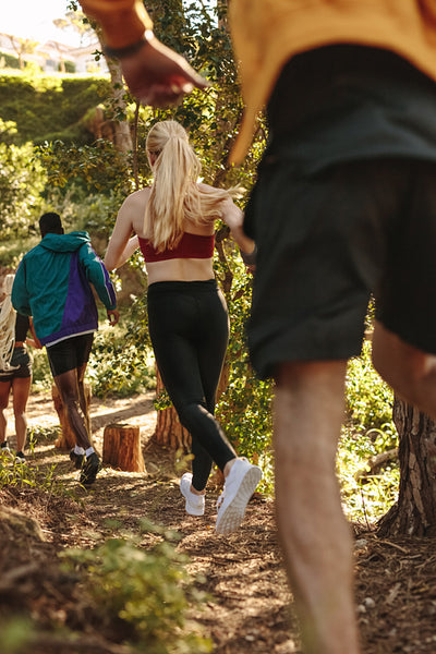 Group of athletes run uphill trail