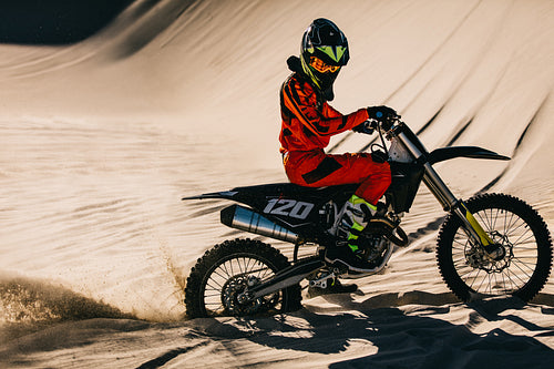 Motocross rider churning up sand