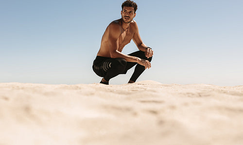 Man relaxing after workout on the beach
