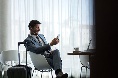 Businessman waiting for flight at airport cafe