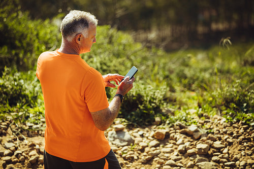 Senior man walking on a rocky path