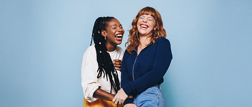 Gen Z friends laughing together in casual studio portrait