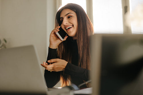 Businesswoman in casuals making a phone call in office
