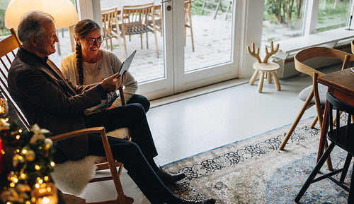 Happy senior couple making video call on christmas