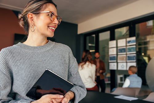 Smiling businesswoman looking away thoughtfully