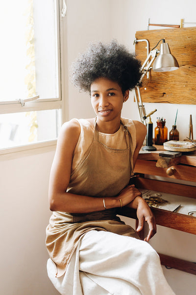 Confident female designer in jewelry workshop