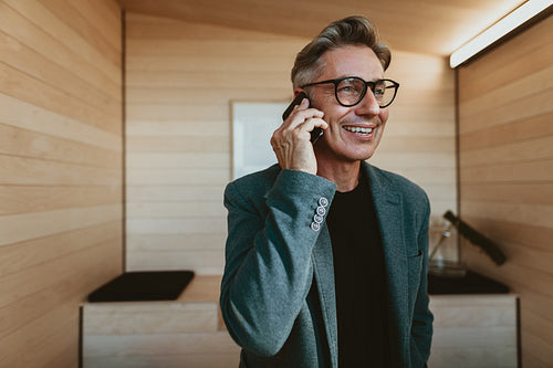 Mature businessman talking on phone