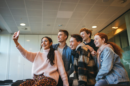 Students sitting in classroom posing for selfie