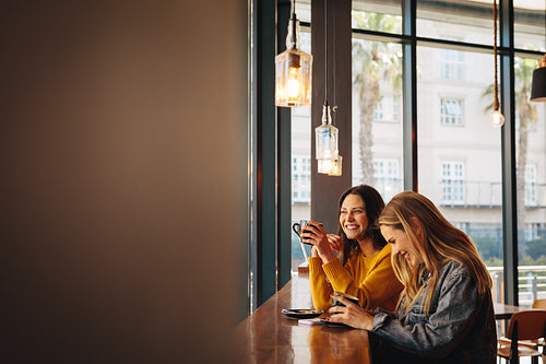 Friends chatting while drinking coffee