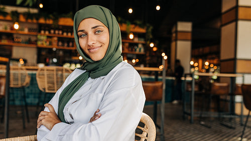 Portrait of a Muslim woman sitting in a cafe