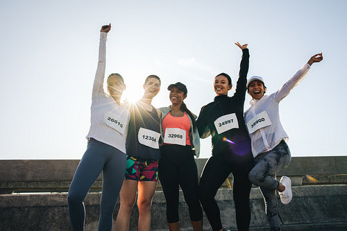 Female friends celebrating after completing a road race