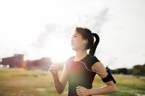 Young fitness woman on morning run in the park