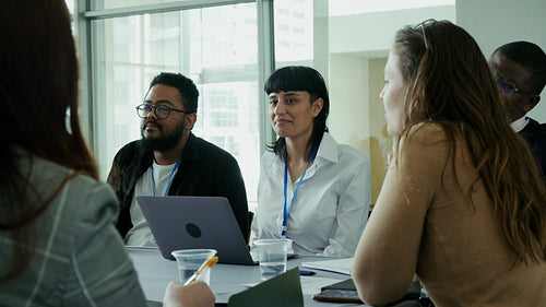 Colleagues sharing ideas and smiling