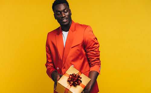 Stylish african man with a gift