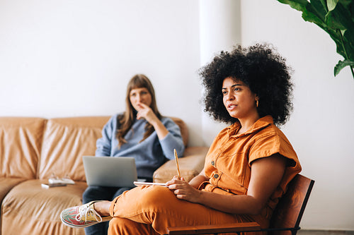 Businesswoman sitting in a meeting with her colleague
