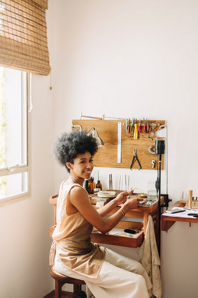 Young artist doing work on jewelry