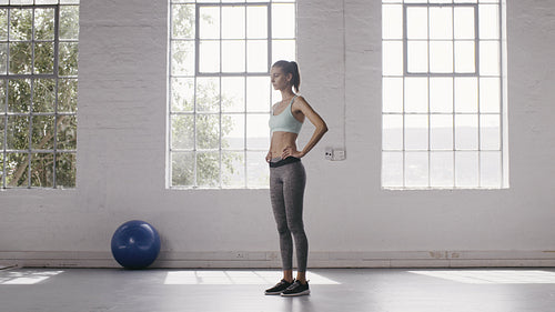 Woman exercising standing Lunges in fitness studio
