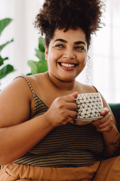 Woman looking away while having coffee