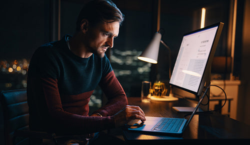 Dedicated businessman working late into the night, strategizing in his home office