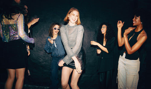 Friends enjoying a festive party with music and dancing