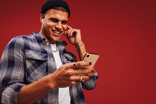 Young man streaming his favourite playlists