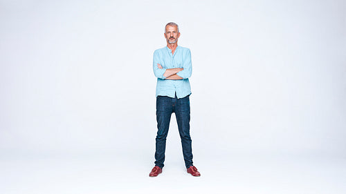 Senior man standing with arms crossed