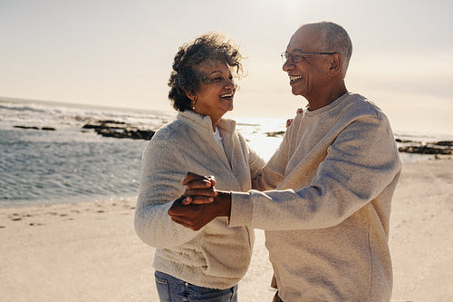 Senior couple dancing together at the beach