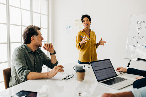 Professional woman discusses a project with her team