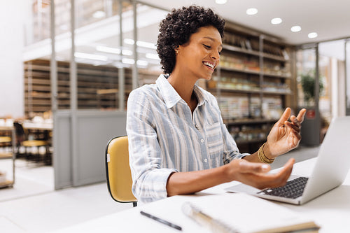 Cheerful businesswoman having a video call in a warehouse